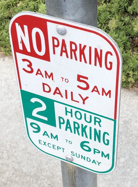 No parking 3 AM–5 AM daily. 2 hour parking 9 AM–6 PM, except Sunday.